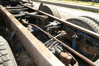 Peterbilt 357 chassis showing exposed frame rails, drivetrain, and suspension components with dual rear wheels.