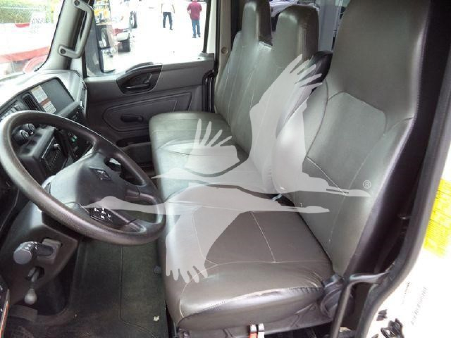 Interior cabin of a 2021 Altec L37M crane showing driver’s seat and passenger seat with steering wheel and dashboard visible.