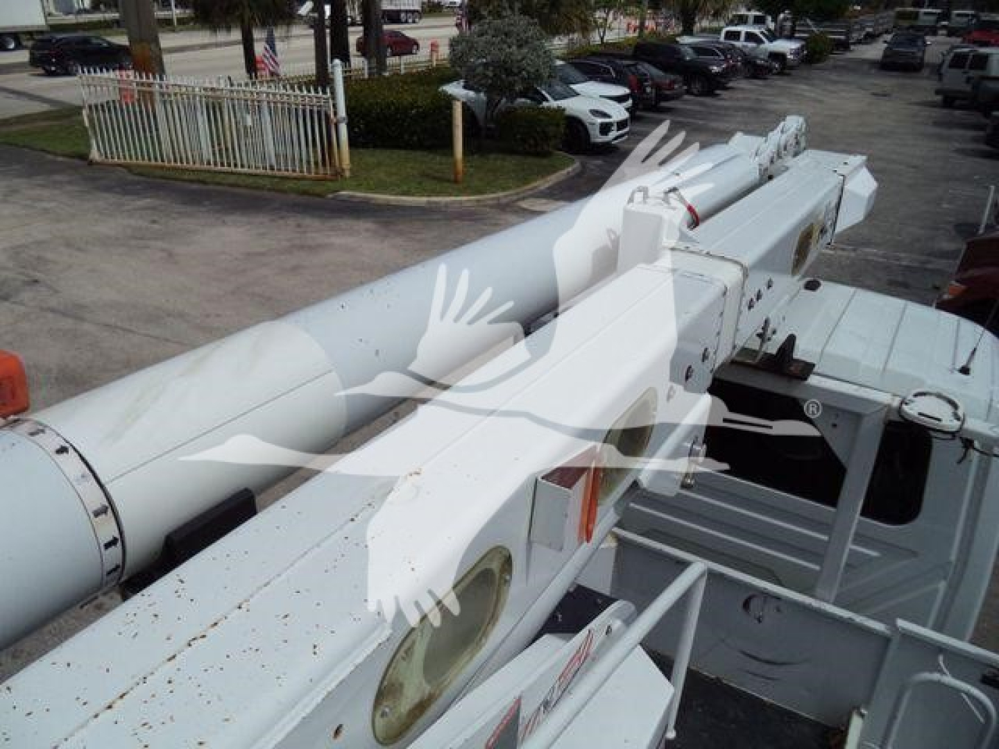 Altec L37M crane arm in service position showing white structural components and hydraulic sections.