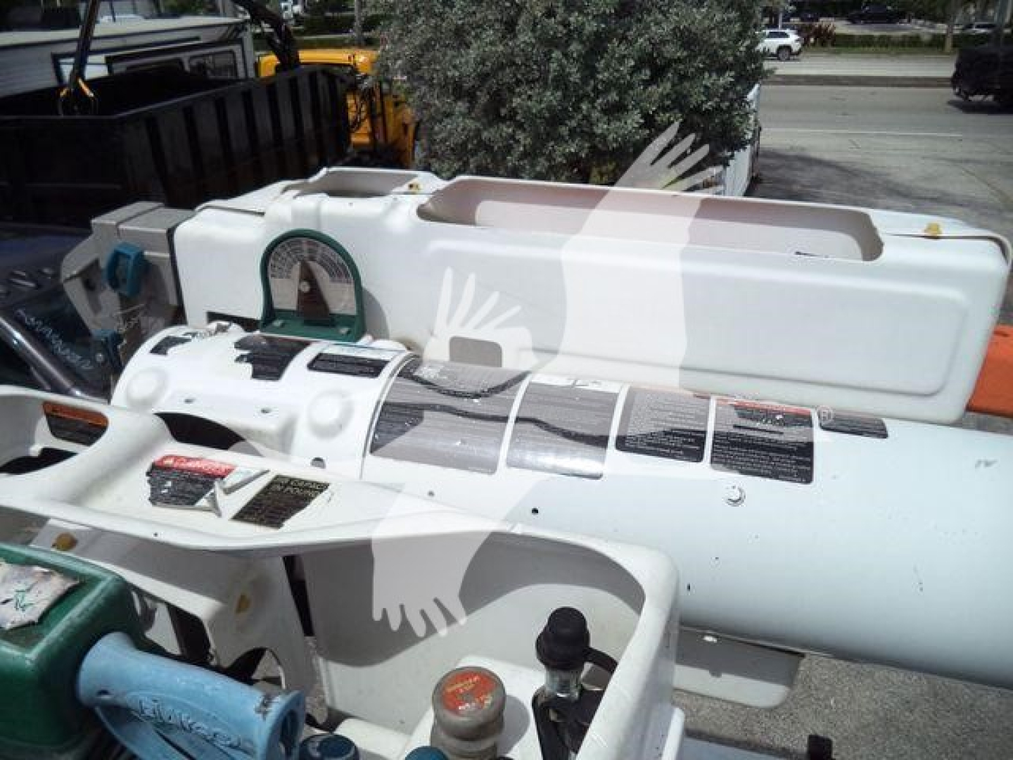 Equipment close-up showing a white Altec L37M crane with control panels and labels on the side; stock number T16079 visible with a black hydraulic reservoir cap and safety decals.