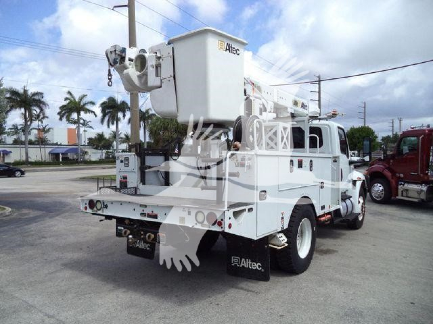 Altec L37M bucket crane on a white service truck, rear view showing elevated bucket platform and hydraulic boom, stock number T16079.