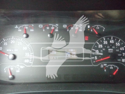 Altec L37M crane dashboard showing gauge cluster with RPM, speedometer, fuel, and hydraulic indicators. Central display with hours and volts/temps; warning icons visible.