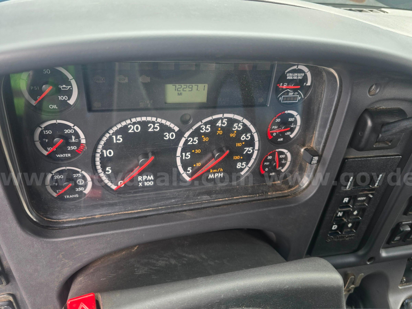 Dashboard view of a Freightliner M2 106 instrument cluster with multiple gauges and an odometer display, showing RPM, speedometer, and other indicators.