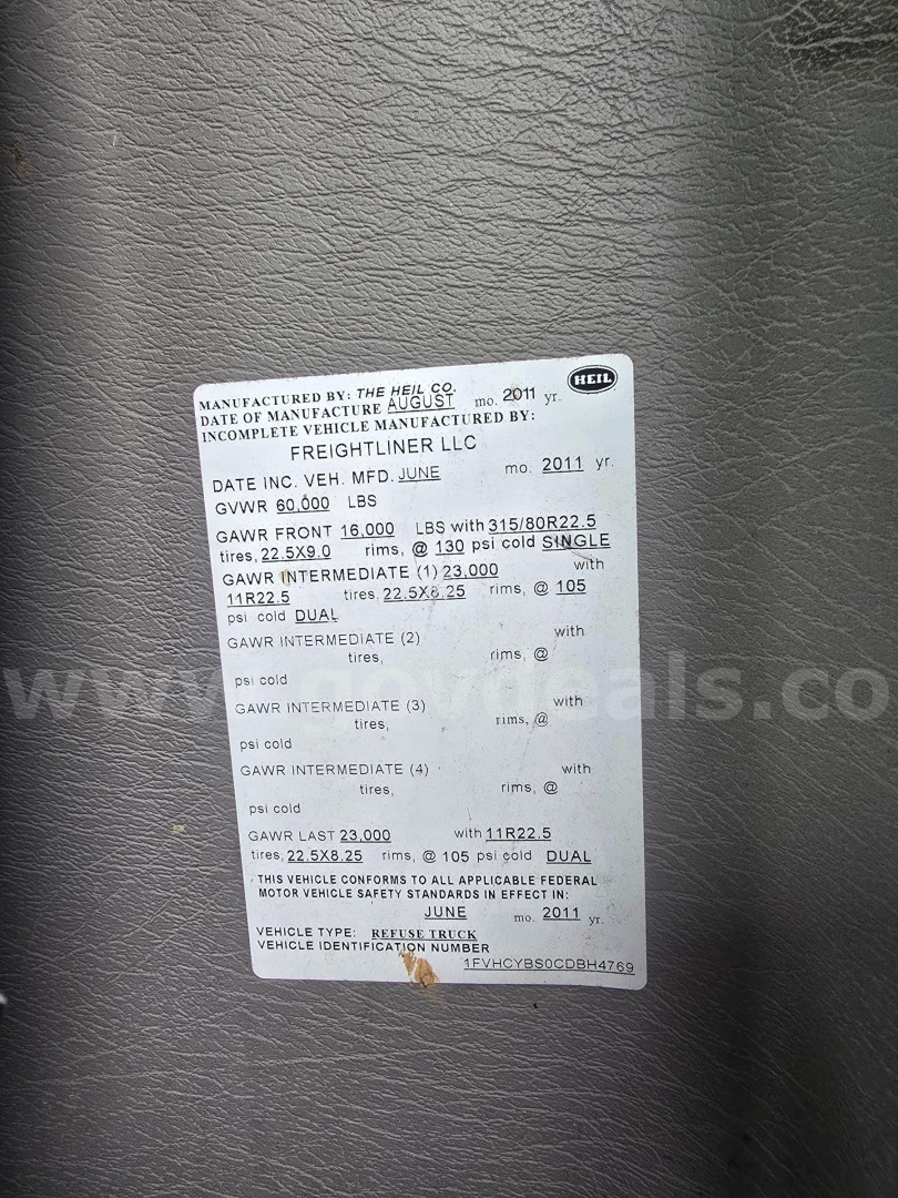 Label with vehicle VIN and GVWR details on a Freightliner M2 106 chassis plate. Includes dates, GAWR, and tire info.