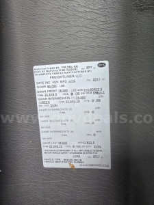 Label with vehicle VIN and GVWR details on a Freightliner M2 106 chassis plate. Includes dates, GAWR, and tire info.