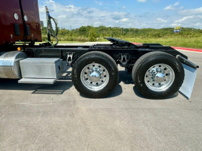 Kenworth T680 chassis side view showing dual rear axles and aluminum toolbox.