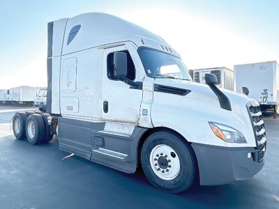 Truck tractor 2023 Freightliner Cascadia126 side-front view showing Sleeper cab, aluminum wheels, gray lower panels, fuel tanks, and dual rear axles.