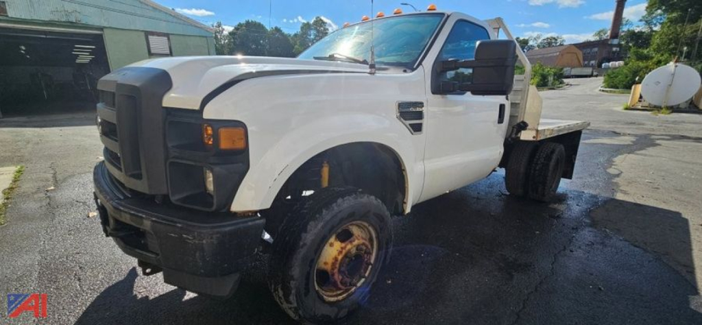 Ford F-350 Super Duty dual rear wheel flatbed at front view showing front grille and bumper.