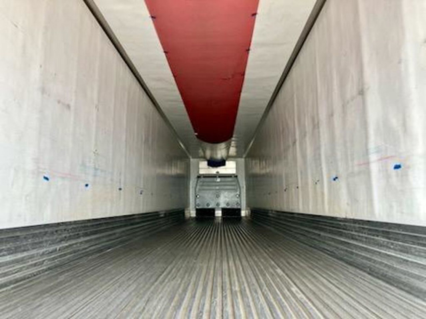 Trailer interior view of a 2017 refrigerated trailer with red ceiling liner and ribbed metal floor, empty cargo area, rear doors visible.
