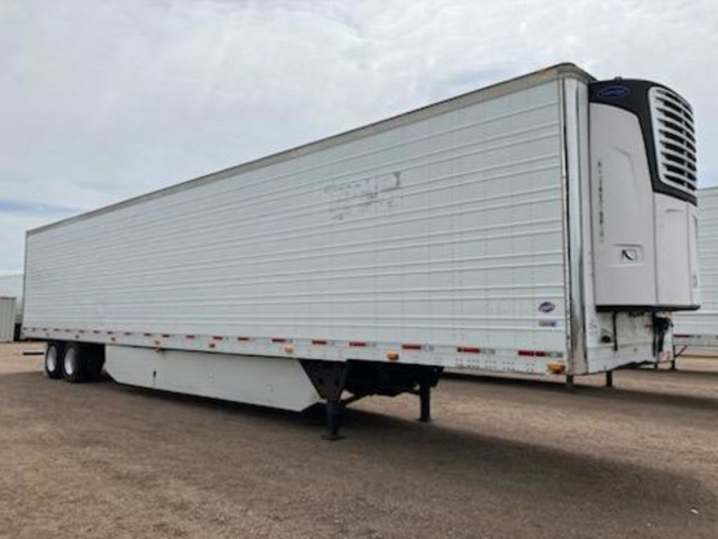 Trailer refrigeration unit with front-mounted reefer compressor, side rail, and landing gear visible; 2017 Utility Reefer trailer in used condition.