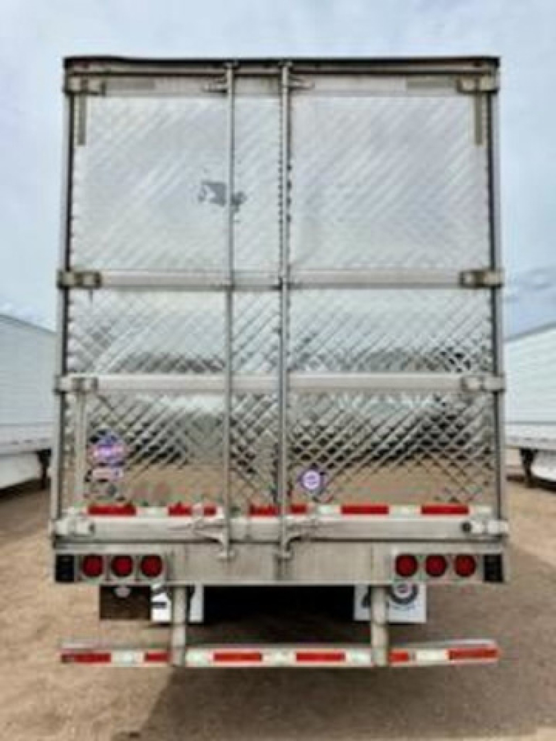 Rear view of a 2017 Utility Reefer trailer with diamond plate doors, dual hinged rear doors, reflective red/white safety markings, and taillights.