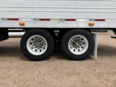 Trailer rear dual wheels of a 2017 Utility Reefer undercarriage showing tires and side rails.