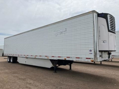 Trailer refrigeration unit with front-mounted reefer compressor, side rail, and landing gear visible; 2017 Utility Reefer trailer in used condition.