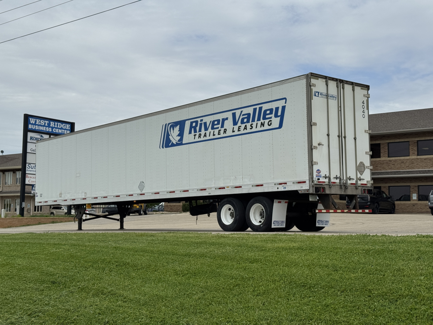 Trailer showing River Valley Trailer Leasing logo on side, white 53-foot trailer parked on a lot with grass foreground.