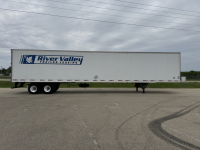 Long white trailer with River Valley Trailer Leasing logo on blue graphic, tandem axles at back, parked on lot.