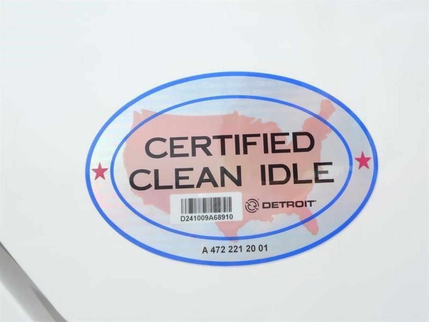 Certified Clean Idle oval sticker with barcode on white surface, Detroit logo, and blue ring border.