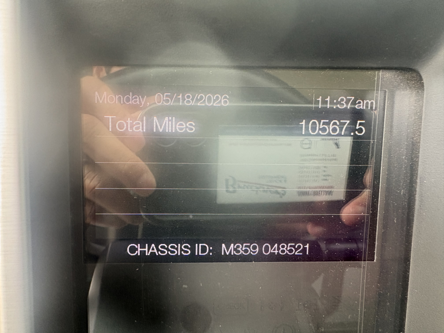 Dashboard display showing total miles 10567.5 and chassis ID M359 048521 on Mack truck.