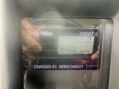 Dashboard display showing total miles 10567.5 and chassis ID M359 048521 on Mack truck.