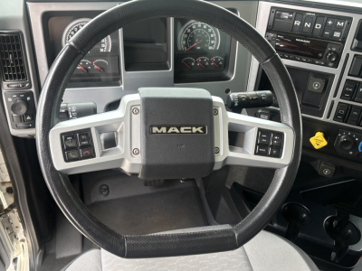 Mack GR64F steering wheel and dash showing instrument cluster and controls.
