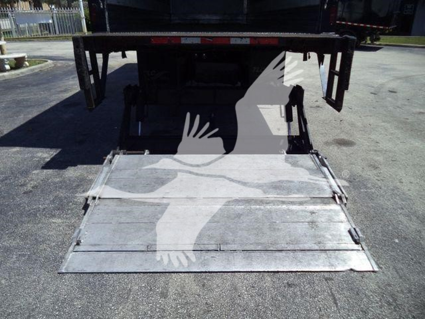 Back of a 2019 Hino 268A refrigeration truck showing a folded aluminum ramp and access area.