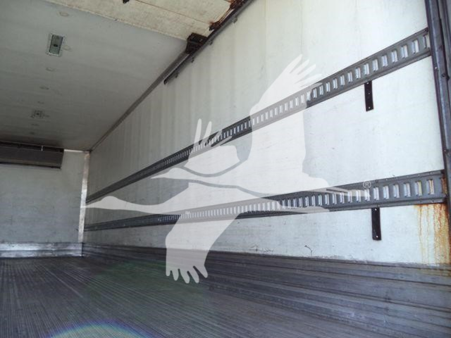 Truck cargo area of a 2019 Hino 268A refrigerated box showing interior walls and cargo straps.