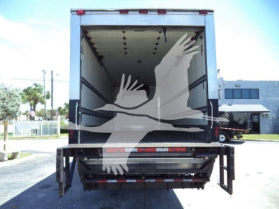 Refrigerated truck with open rear doors showing cargo area of a 2019 Hino 268A in a yard.