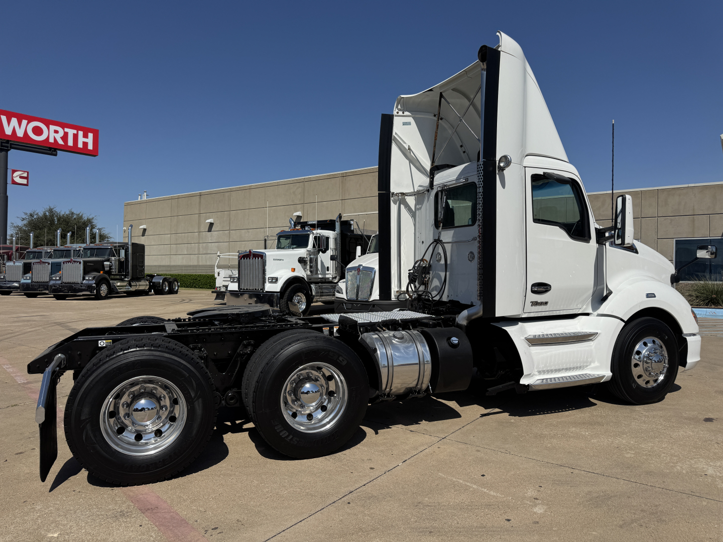 Kenworth T680 tractor in white, side view showing chassis and rear wheels.