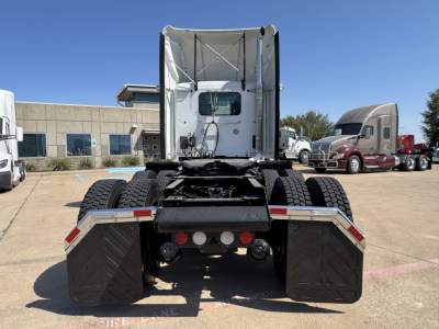 Kenworth T680 rear view showing dual rear tires and mud flaps, with license-free area and fifth-wheel hitch mounting.
