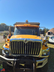 Front view of a yellow 2008 International WorkStar 7500 dump truck showing large chrome grille, headlights, and bumper.