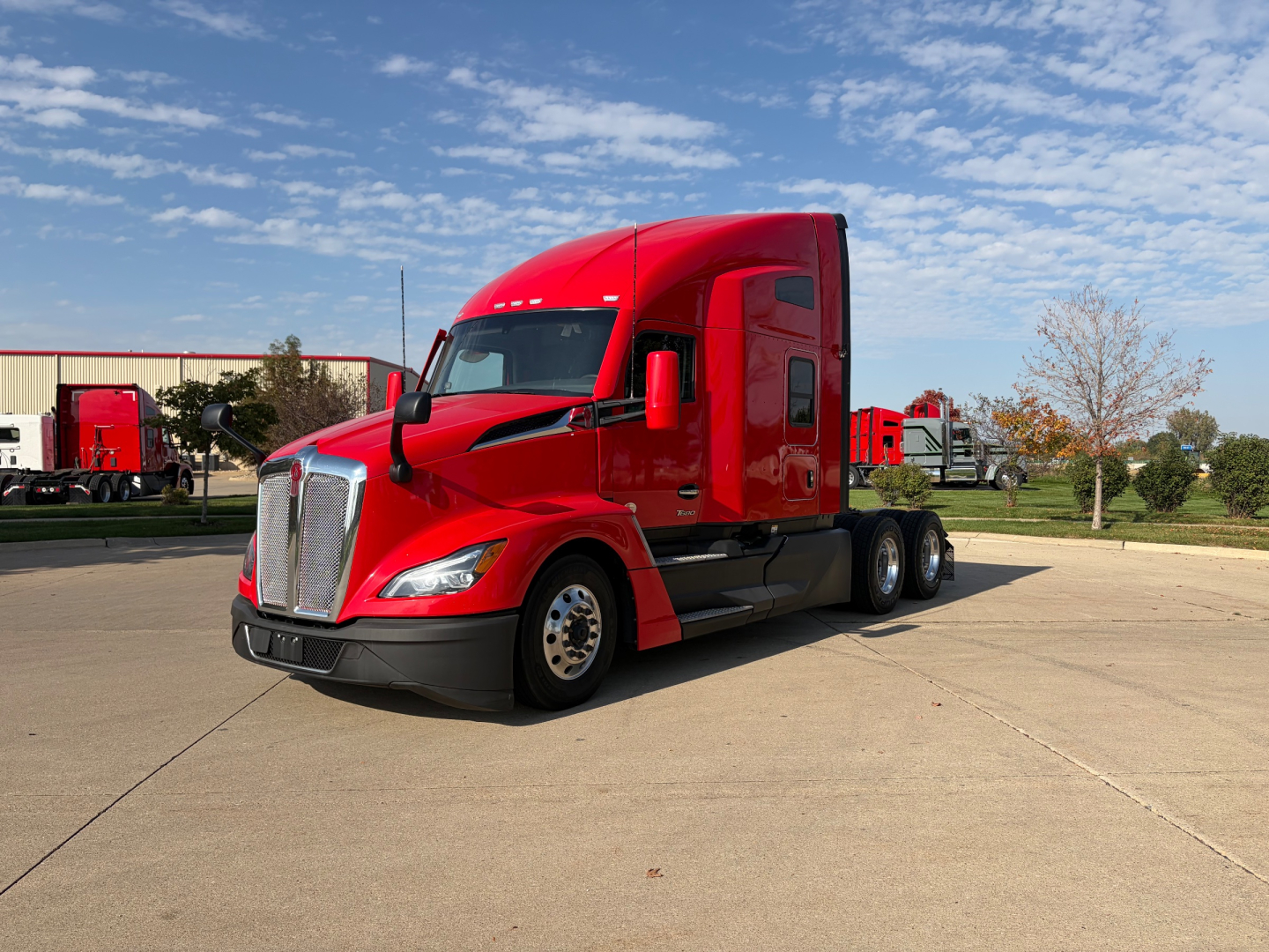 Kenworth T680 tractor in red, front-left view.