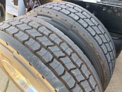 Kenworth T680 wheel and tire tread close-up in truck chassis showing dual rear tires.