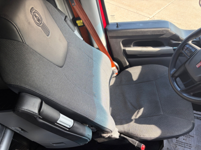 Kenworth T680 truck interior driver seat and steering wheel with fabric seat cover and armrest