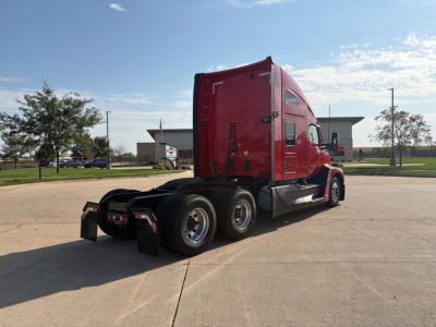 Kenworth T680 sleeper tractor rear-left view showing dual rear axles and red cab with black frame.