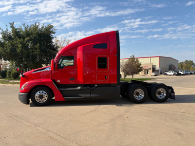 Kenworth T680 tractor in red, side view showing sleeper cab, rear tandem wheels, and chassis.
