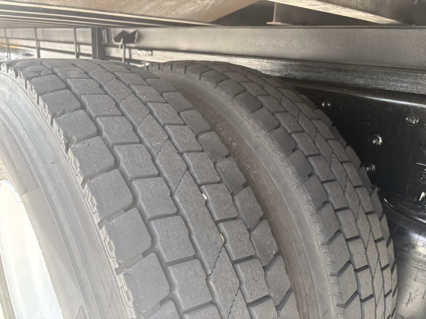 Truck axle with dual tires in view under frame. No legible labels visible.