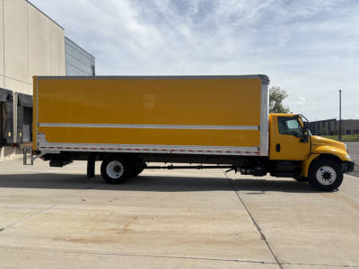 Truck side view showing a yellow box truck with a large cargo box and cab, 2021 International MV607, stock 0631114, VIN 3HAEUMML3ML479363.