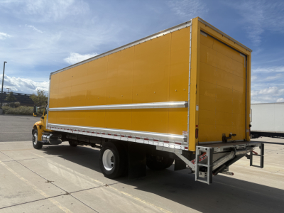 Truck with a yellow box body, side view showing rear and driver's cab. No legible text visible on panels.