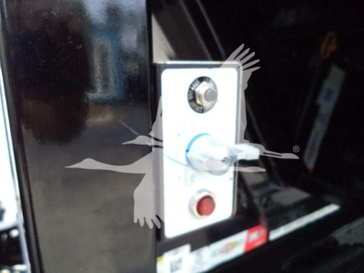 Isuzu NR rollover truck control panel with red and white push buttons and a blue-tipped selector lever visible.