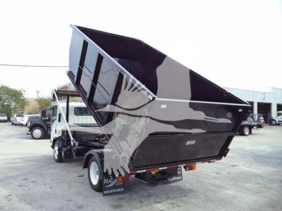 Isuzu NPR rollover truck with a raised black dump bed, side view showing rear wheels and dumping container.