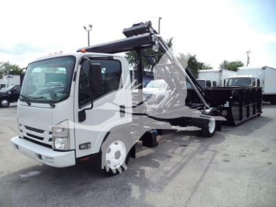 Isuzu NPR roll-off truck with front cab and hooklift hoist in view showing crane and dump bed.