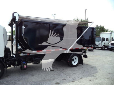Isuzu NPR rolloff truck side view showing dumped cargo bed and rear wheels