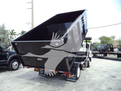 Isuzu NRR truck with a raised black dump bed in a lot; rear view shows license plate area and small text on mudflaps; no other readable labels visible.