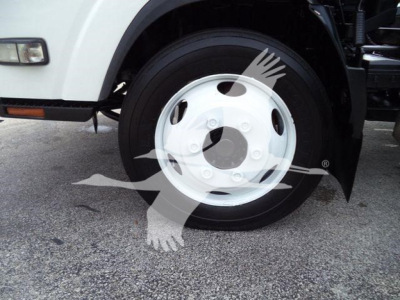 Isuzu NPR truck wheel and front fender showing white steel wheel and tire.