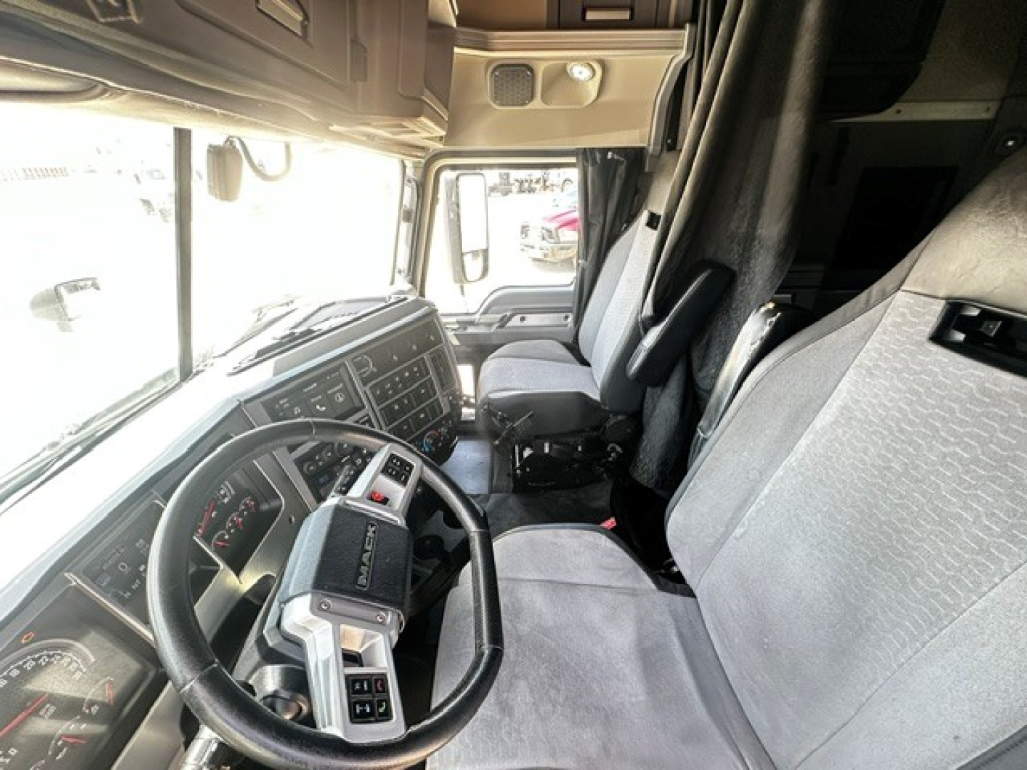 Interior of a 2020 Mack Anthem truck cab showing steering wheel and driver seat area with dashboard controls.
