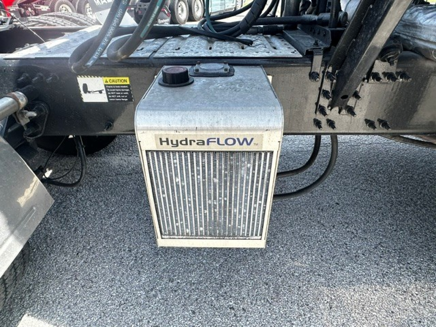 HydraFLOW auxiliary fuel tank/power unit attached under a 2020 Mack ANTHEM truck showing hoses and mounting brackets.