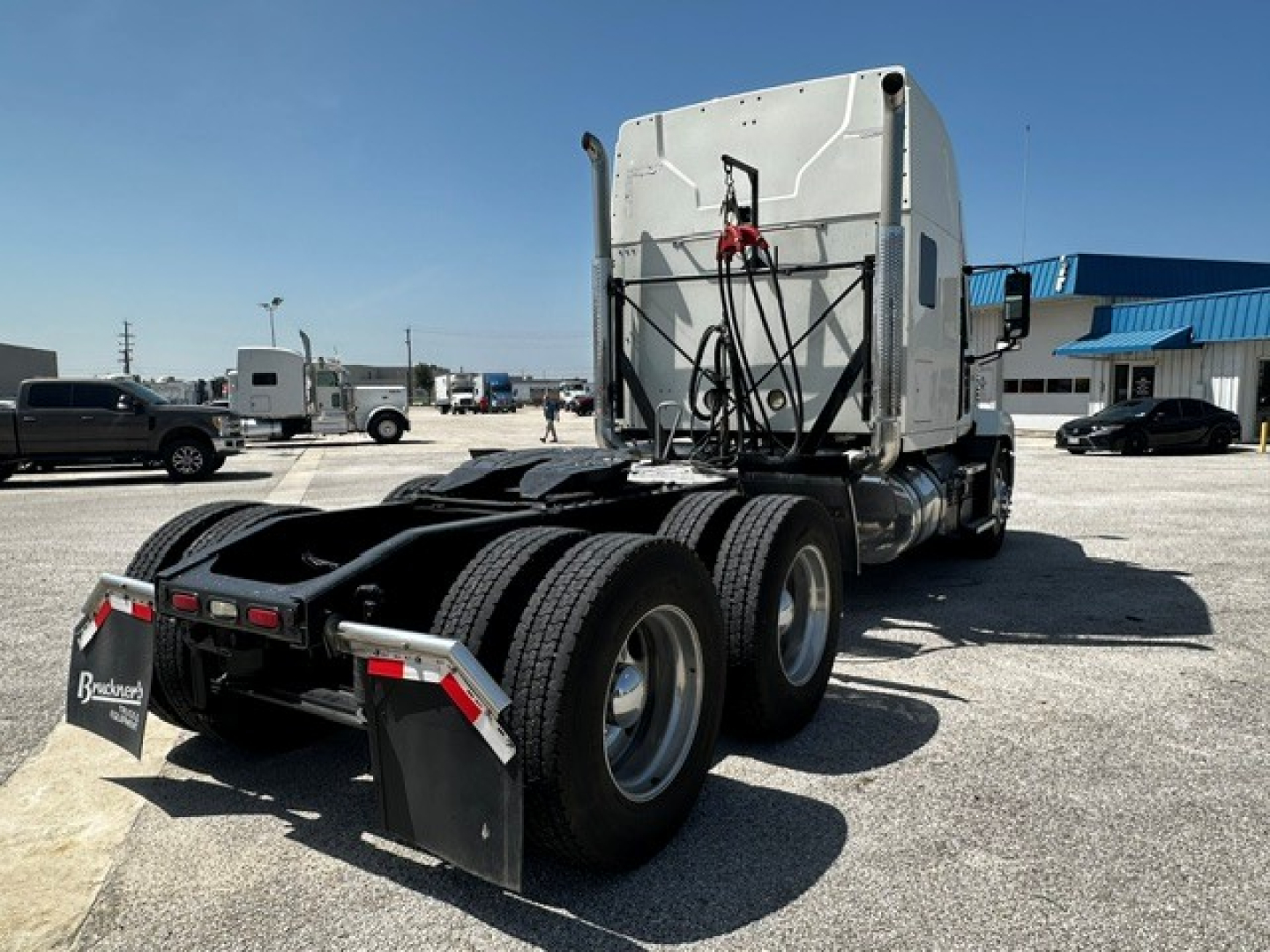 Truck tractor rear and cab view of a 2020 Mack Anthem sleeper with dual rear axles and fifth wheel; visible rear fenders, mud flaps, and connectors.