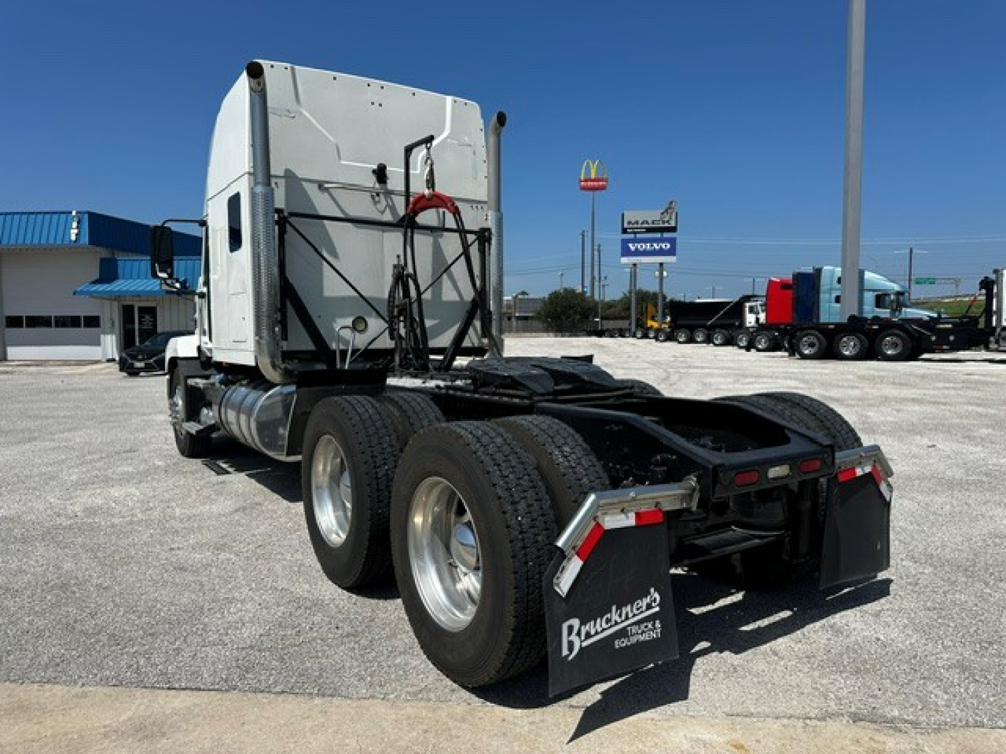 Back of a 2020 Mack Anthem tractor tractor-trailer chassis with dual rear axles, mud flaps reading Mack Trucks, and a fuel tank visible. License plate not shown.