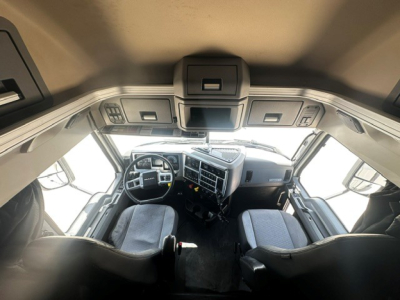 Cab interior of a 2020 Mack Anthem truck with steering wheel, dashboard, and two seats visible.