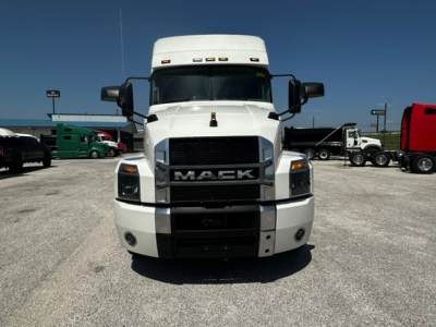 Front view of a white 2020 Mack Anthem conventional sleeper truck showing Mack grille and bumper with headlights.