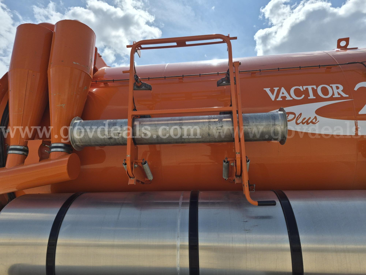 Freightliner 114SD vacuum truck tank showing Vactor Plus branding and equipment beam.